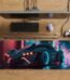 ARNA artificial intelligence designed racing car standing on a night street featuring glowing red neon headlights and vibrant blue custom wheel rims extended large desk mat.