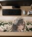 ARNA picturesque peaceful anime girl with a white flower woven in her hair standing in a vibrant endless blossom meadow farm extended large desk mat